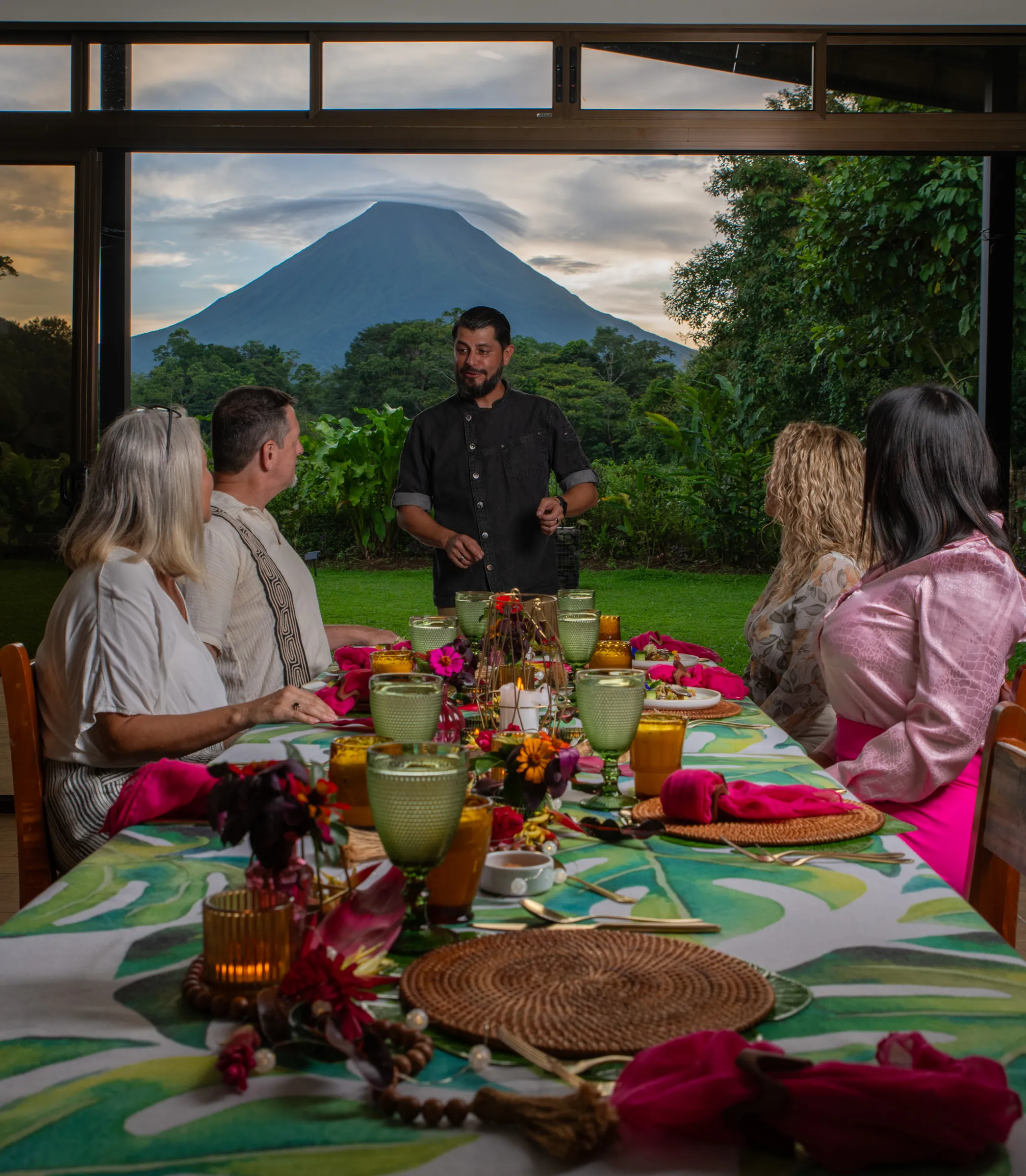 Chef Arthuro with guests, the volcano in view