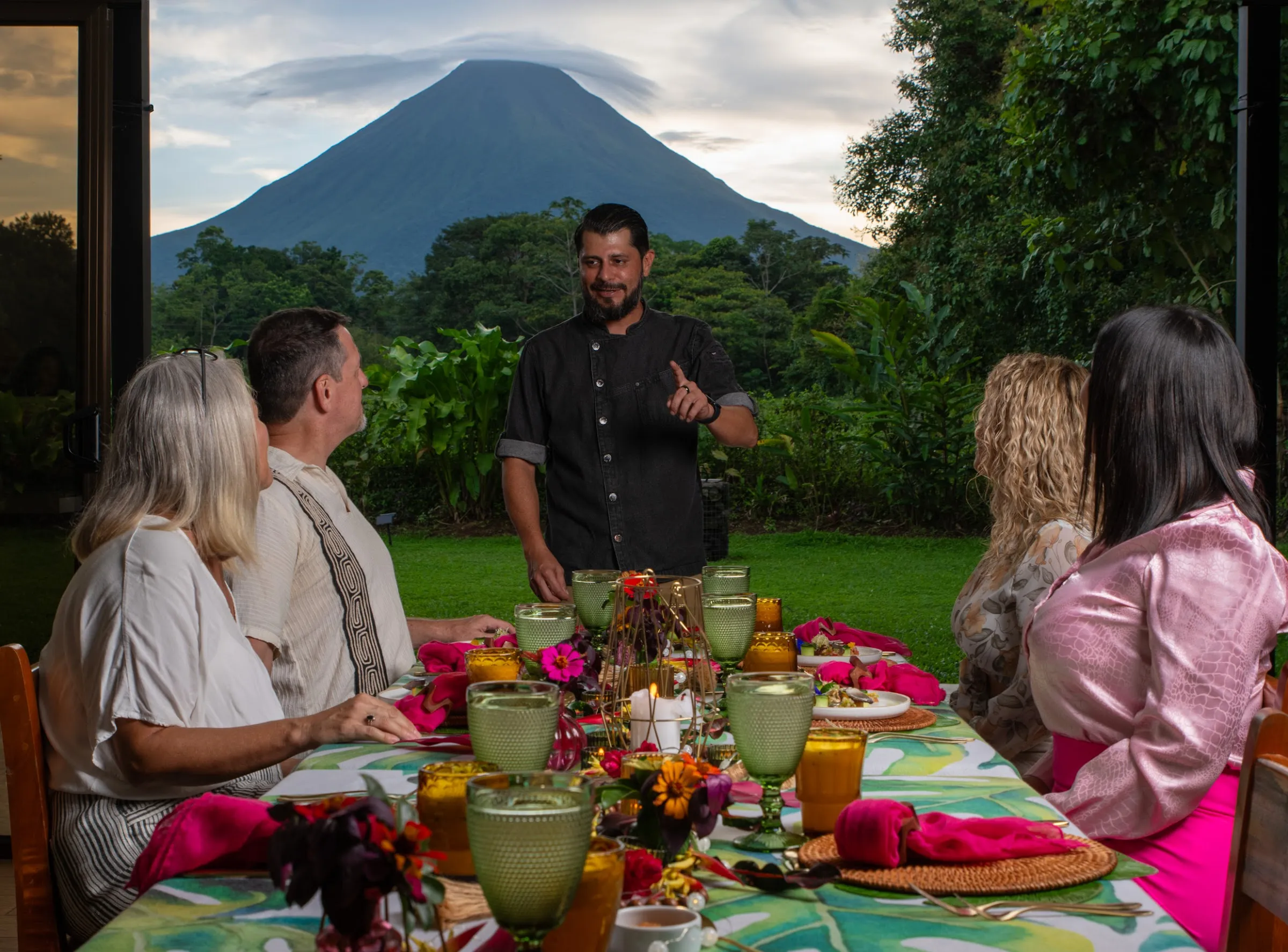 Chef Arthuro Paniagua at the table with Arenal Volcano behind